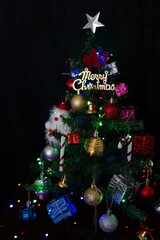christmas tree and decorations on black background
