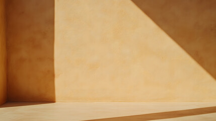 Stucco yellow wall is illuminated by the harsh midday sun, creating bold, strong shadows that highlight the texture and architectural details