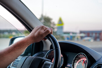 male driver is driving a car during a traffic jam in the capital. driving on the left