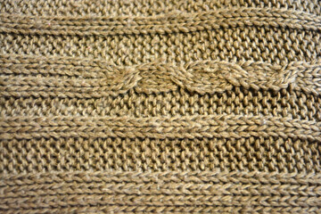 Women's clothing, stylish knitwear made of natural woolen dense threads. Beautiful patterns, braids, nice, soft braided woolen fabric.