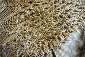 Women's clothing, stylish knitwear made of natural woolen dense threads. Beautiful patterns, braids, nice, soft braided woolen fabric.