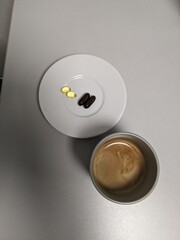 A medical concept scene of a cup of coffee paired with daily medicine pills, highlighting patient compliance and routine medication managementmedical concept, cup of coffee, medicine pills, patient co
