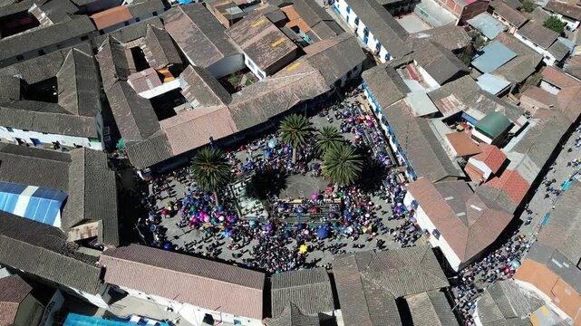Drone shot of Paucartambo's main square during the Feast of the Virgen del Carmen, capturing vibrant festivities and the lively cultural atmosphere in this picturesque Peruvian town