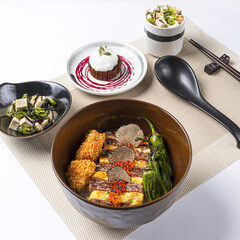 Japanese Wagyu Sirloin Bento with Tofu seaweed salad served in bowl and Chocolate lava cake ice cream isolated on napkin side view of Japanese food on white background