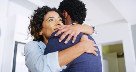 Love, embrace and couple in home with reunion, trust and comfort in kitchen together for...