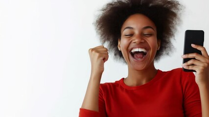 A joyful woman celebrates while holding her smartphone