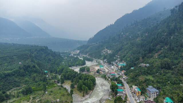 Aerial view of manali with the beas river and national highway 3 in himachal pradesh India. Small villages and colourful local houses nestled in the hills of manali himachal pradesh India.