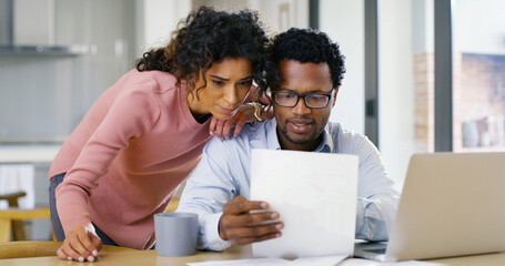 Interracial couple, documents and laptop with expenses for budget planning, bills or assets at...
