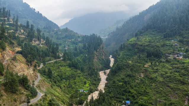 Aerial view of manikaran town with the parvati river and local houses in the parvati valley at himachal pradesh state of India.