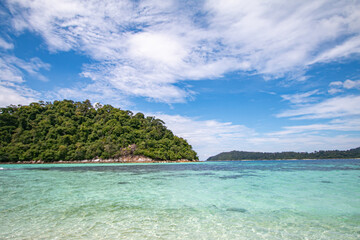 The blue sky and the clear green sea are beautiful.