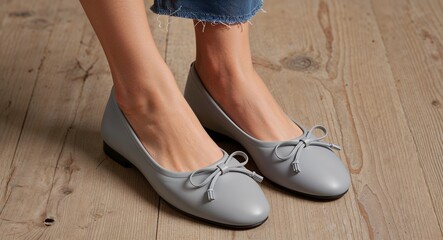 Womens gray ballet flats with a bow detail and soft leather finish ivory background 