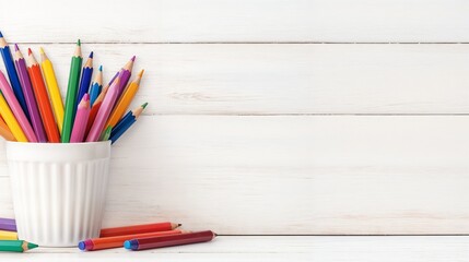 Obraz premium Colorful pencils in white cup on wooden table, copy space, knowledge day