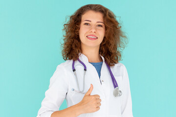 Smiling professional doctor in medical uniform shows thumbs up. Pleased female physician confirms smth, recommending product, blue background