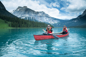 Two young women kayaking in a lake, Yoho National Park, British Columbia, Canada
