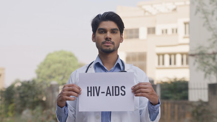 Indian Doctor Holding HIV-AIDS Poster