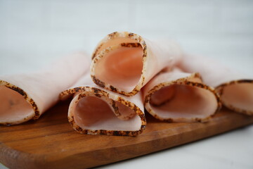Sliced ham on wooden cutting board. Fresh prosciutto. Pork ham sliced