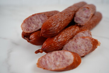 A pile of smoked sliced kabanos sausages