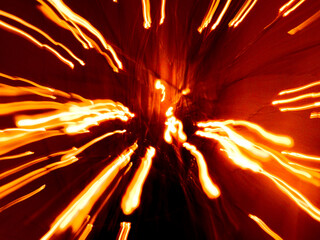 Abstract orangey red light streaks against a dark background