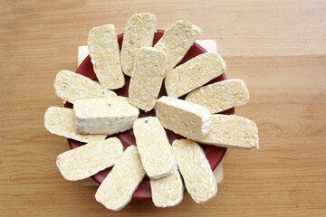raw tempeh on wooden table