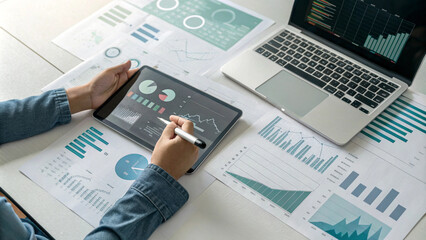 An analyst uses a computer and dashboard for data business analysis and Data Management System with KPI and metrics connected to the database for technology finance, operations, sales, marketing