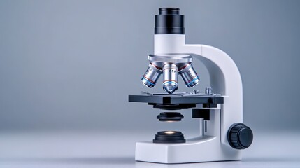 A modern microscope on a neutral background for scientific study.