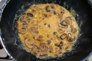 Scrambled eggs with sautéed mushrooms cooking in a frying pan. A close-up of a healthy, protein-rich breakfast with vibrant textures and colors, perfect for culinary or food-related concepts.