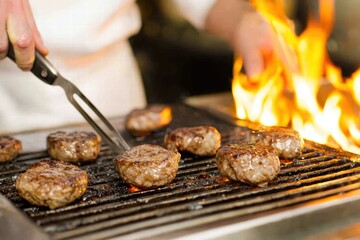 Grilling Delicious Fresh Burgers Over Open Flames in Kitchen