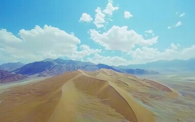 Naklejka premium Vast Desert Landscape Under Bright Blue Sky with Fluffy Clouds