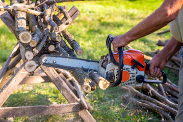 Man cutting wood with chainsaw