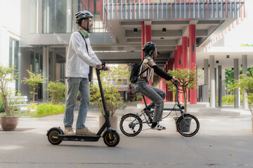 Commuting to work with bicycle. Young business person cycling and riding electric scooter to office...