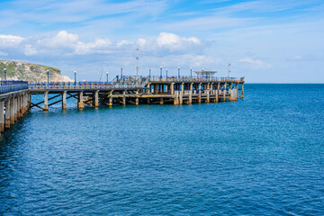 Swanage, Dorset, England, UK - 18 April 2021: Swanage Pier, Victorian pier on the eastern coast of the Isle of Purbeck