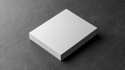 Fototapeta premium Stack of Blank White Business Cards on a Dark Stone Background for Branding Mockup and Design Presentation