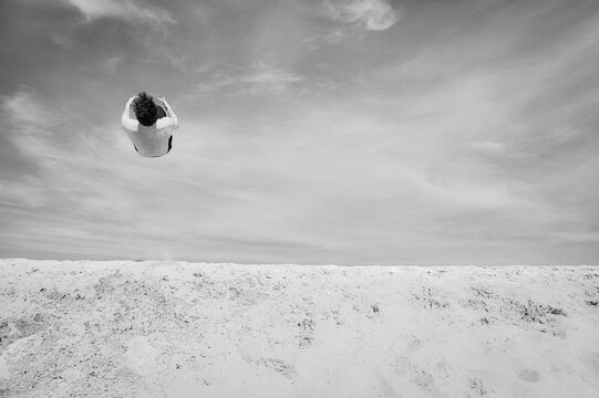 person jumping on the beach