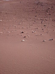 sand background with stones, red sand of atacama desert. Nature dry arid background.