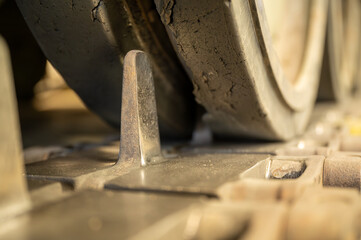 Close-up of the track and drive train of a military tracked vehicle