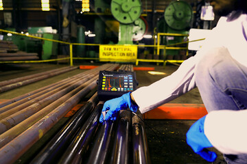 metal testing with a machine, raw material testing, metal hardness tester machine equiment on a alloy steel piece quality control process in a metal tool component manufacturing factory 