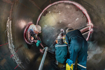 Inside male worker into the inspection shiny tank industrial construction oil and gas or storage tank oil chemical into area