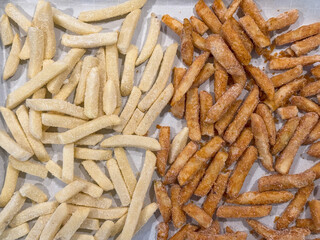 Frozen Coated And Seasoned French Fries On Wax Paper Ready To Be Baked At Home