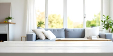 A wooden table with a blurred sofa in the background, in a bright and airy room with large windows