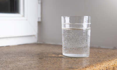 Glass of water on windowsill.