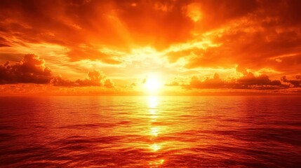 Obraz premium Fiery sunset over calm, orange ocean.