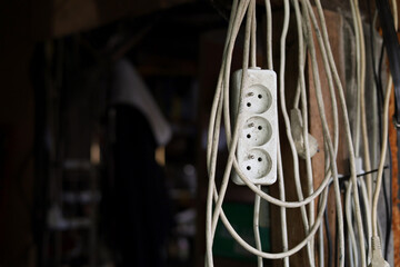 Dirty coil of extension cords hanging in the old workshop