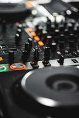 closeup of professional digital pioneer dj decks and audio mixer equipment ready for party in...