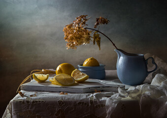 Still life with lemons and dry hydrangea on a dark background