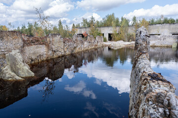 Abandoned Industrial Ruins Reflected in Serene Waters of a Sulfuric Landscape