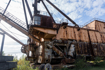 Fototapeta premium Abandoned Industrial Machinery in a Verdant Landscape