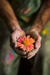 Artisan Hands Holding a Vibrant Pink Flower: Symbol of Care, Creativity, and Natures Beauty in Clay-Stained Grip &acirc;&euro;&ldquo; Perfect for Eco and Art Themes.