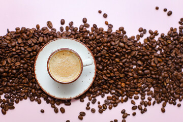 coffee cup with coffee beans on pastel background. flat lay, top view