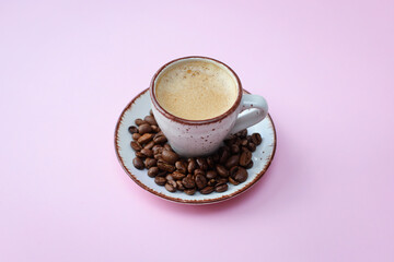 coffee cup with coffee beans on pastel background. flat lay, top view