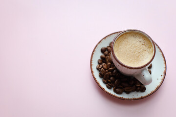 coffee cup with coffee beans on pastel background. flat lay, top view